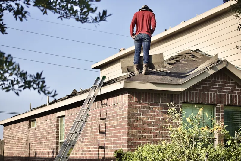 Professional roofer working on a residential roof in Klines Mill